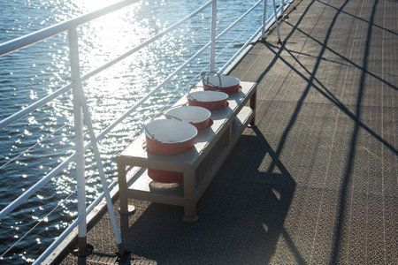 red fire buckets and lifebuoy on the deck of the shipの写真素材
