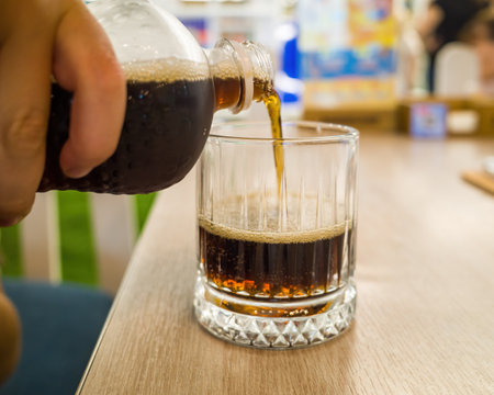 Pour soft drink in glass. close-up