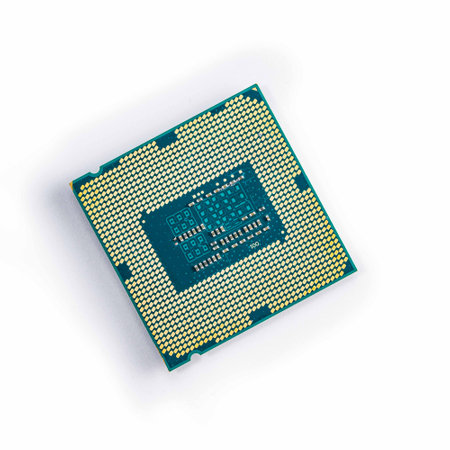 old computer processor with contacts upwards isolated on white.