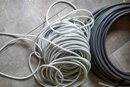 protective plastic corrugation for an electric wire lies on the floor. construction and renovation....