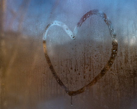 heart painted on the fogged glass.の写真素材