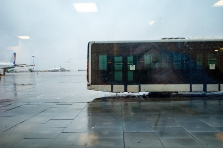 Wet Airport, Rainy view of an airport apron with a bus in the background.の写真素材