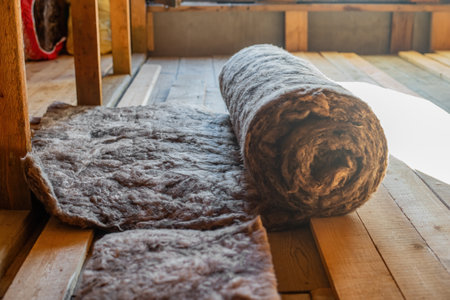 Insulation Installation, Roll of insulation material. Insulation on a wooden surface.の写真素材