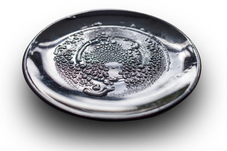 Wet black plate, covered with water drops. isolated on whiteの写真素材