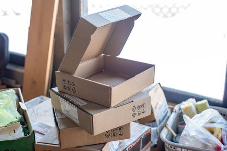 Open cardboard boxes and Stacked shipping containersの写真素材