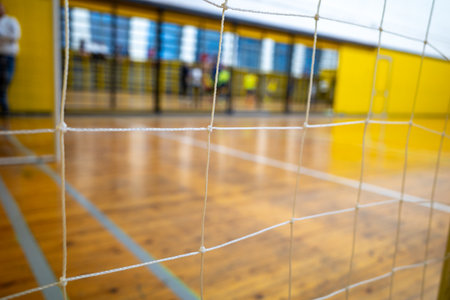 goal net in the gym is in focus, followed by the blurred background of the gymの写真素材