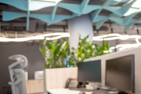 office with bokeh background blurred interior interior with plants, computer monitors, and a white deskの写真素材