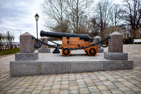 black cannon on a wooden carriage, chained to stone pillars.の写真素材