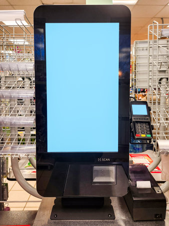 Unmanned cash terminal with blue screen mock up and copy spaceの写真素材