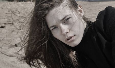 Portrait of beautiful brunette girl on beach