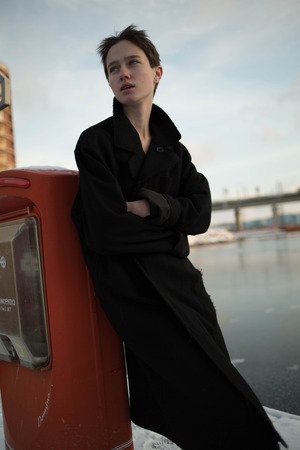 Young stylish woman urban walking under bridgeの写真素材