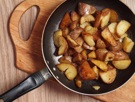 Fried potatoes in a frying panの写真素材