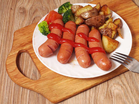 Sausages a plate of vegetables a forkの写真素材