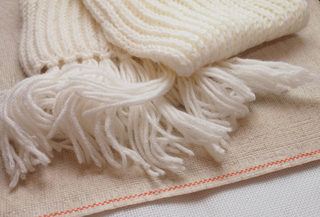 white hand-knitted scarf on canvasの写真素材