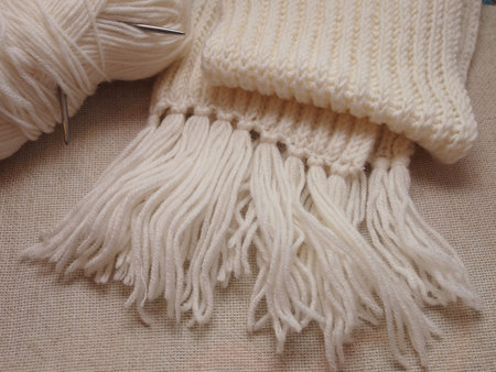 white hand-knitted scarf on canvasの写真素材