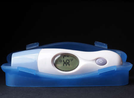 electronic thermometer with normal temperature and smileの写真素材