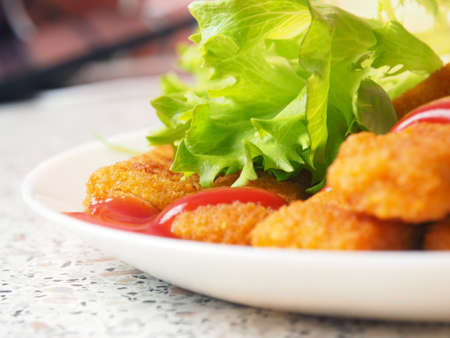 fish sticks chicken sticks breaded nuggets with ketchup and lettuce