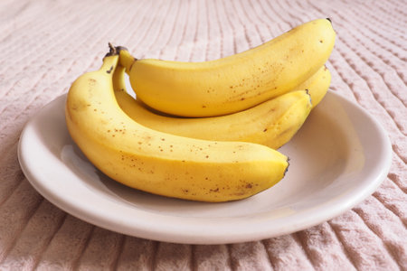 a bunch of ripe bananas on a plateの写真素材