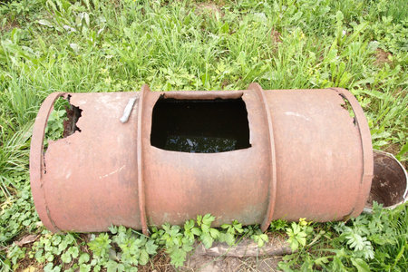 rusty barrel for collecting water in the village