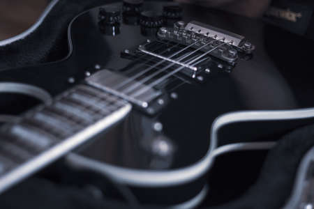 Electric guitar in the case closeup music background
