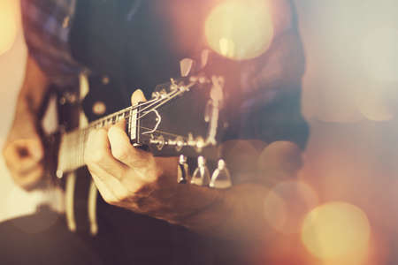 Guitar player close-up, music backgroundの写真素材