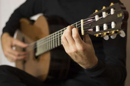 Male musician playing acoustic guitarの写真素材
