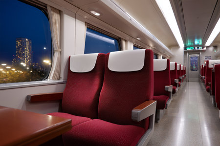 Comfortable train seats in a modern carriage at nightの素材