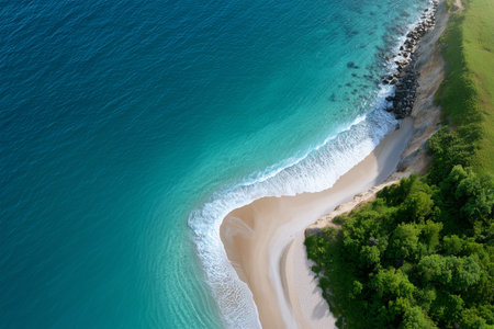 Beautiful coastline with clear blue waves and green landscapeの素材