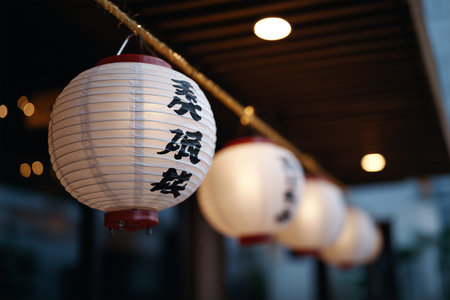 Lanterns illuminate a peaceful evening street scene in a vibrant cityの素材