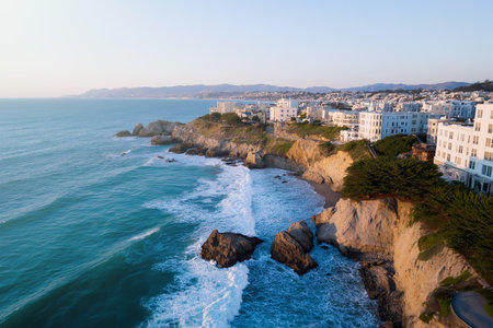 Coastal view of houses along a scenic beachfront at sunsetの素材