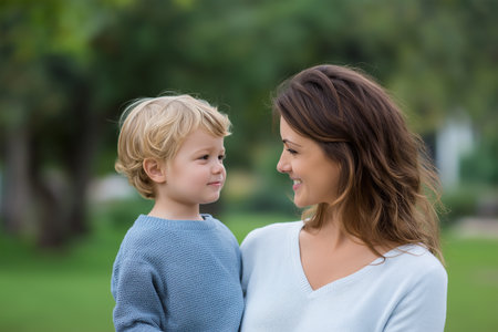 Mother and child share a joyful moment outdoors in the parkの素材