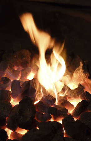 the bright flame and live coals in a smithy