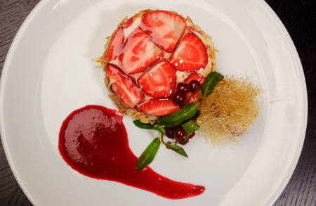 Strawberry dessert on a white dishの写真素材