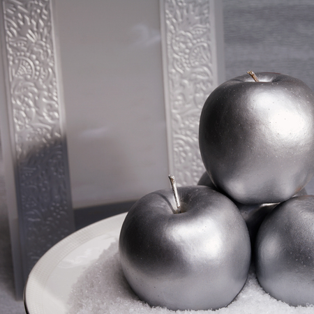 Silver composition. Three silver apples and invitation cardの写真素材