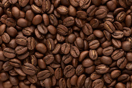 Roasted coffee beans background. Close up top view. High quality photo