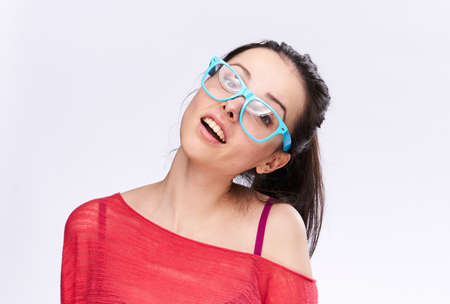 Young woman in transparent blue glasses, portrait on white background.の写真素材