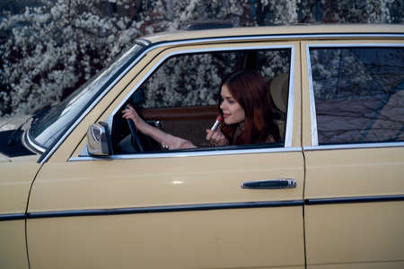 Woman driving a retro car, young woman driving a car.の写真素材