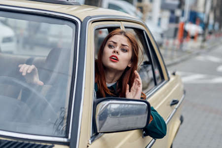 Woman driving a retro car, young woman driving a car.の写真素材