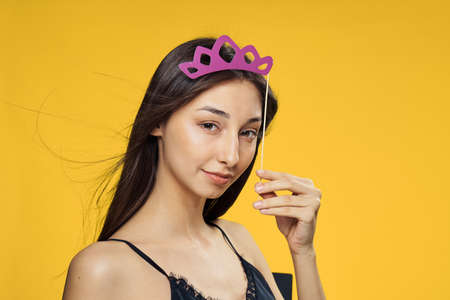 Woman with an accessory on a yellow background.の写真素材