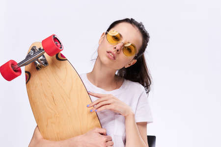 Woman with wails holds skeys on a light background.の写真素材