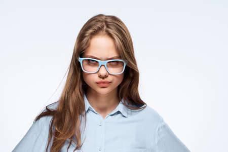 Woman in glasses on a light background portrait.の写真素材