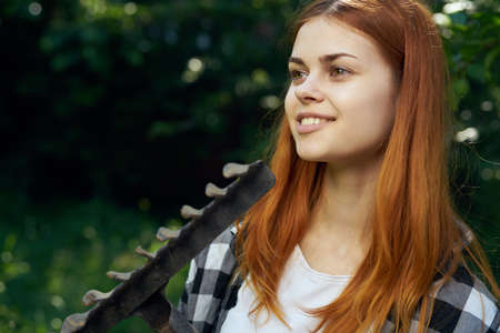 Woman with a pitchfork in the garden.の写真素材