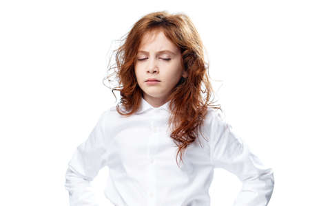 Girl with closed eyes on isolated background.の写真素材