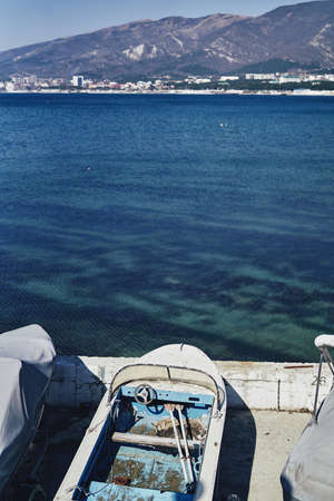 Sea, mountains, pier, old boats, bay, closed boats.の写真素材