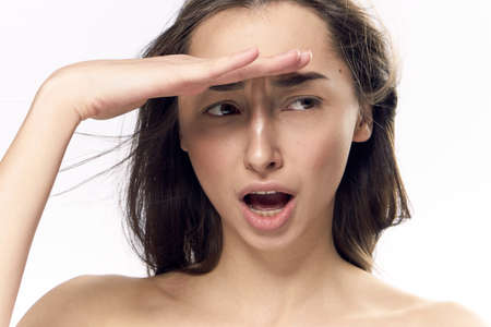 Woman surprised, woman holding her hand near forehead on isolated background.の写真素材