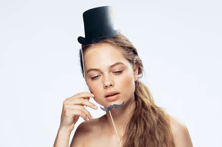 Woman with accessories hat and mustache on isolated background.の写真素材