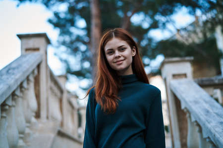 Woman on the background of a ladder, woman smiling.の写真素材