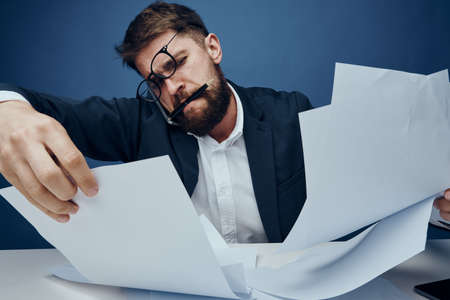 Businessman working, business man talking on the phone wearing glasses, businessman on a blue background.の写真素材