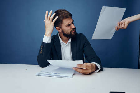 Business man looking at documents, business man unhappy, businessman on blu background.の写真素材