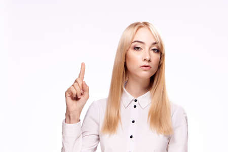 Blond, woman in a white shirt, woman on a light background.の写真素材